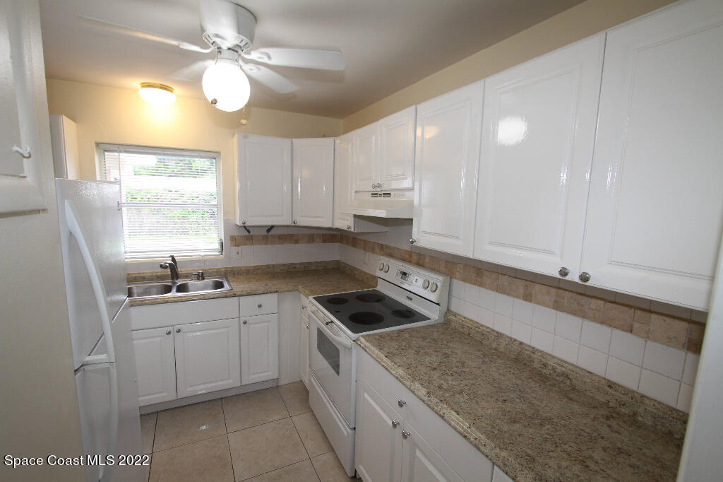 114 1st Street Merritt Island, FL 32953 - Photo 10 of 21 a kitchen with a sink and cabinets