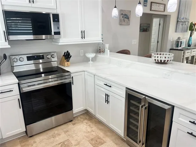 a kitchen with stainless steel appliances a stove microwave and sink