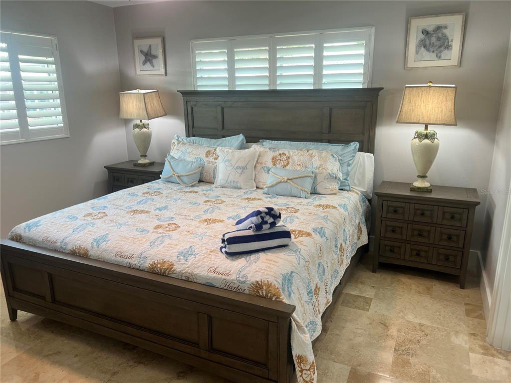 6020 Midnight Pass Road, Unit 22 Sarasota, FL 34242 - Photo 12 of 21 a bedroom with a bed and a night stand