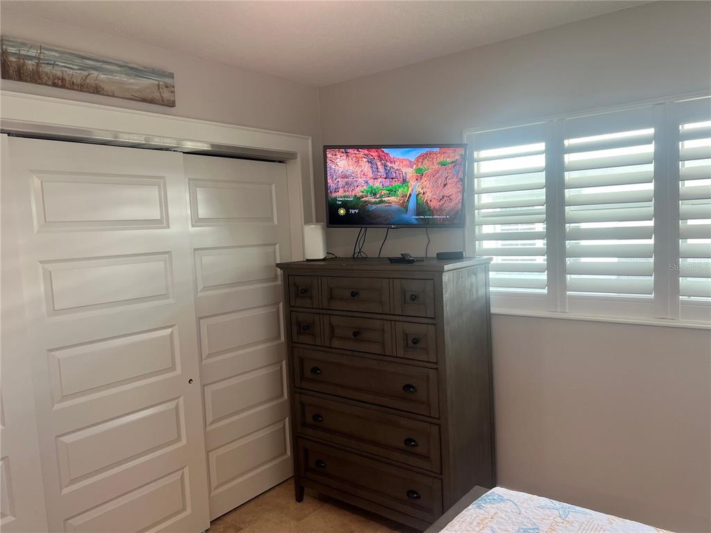 6020 Midnight Pass Road, Unit 22 Sarasota, FL 34242 - Photo 13 of 21 a living room with furniture and a flat screen tv