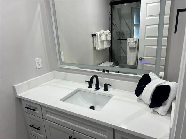 a bathroom with a sink and a mirror
