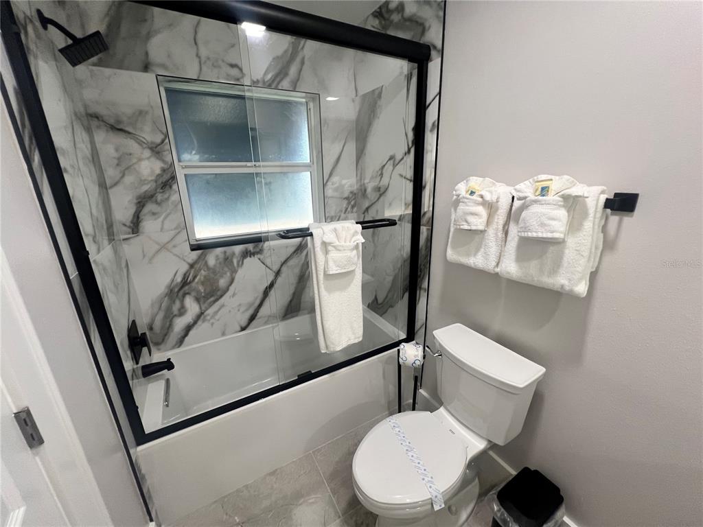 6020 Midnight Pass Road, Unit 22 Sarasota, FL 34242 - Photo 15 of 21 a bathroom with a toilet and a shower