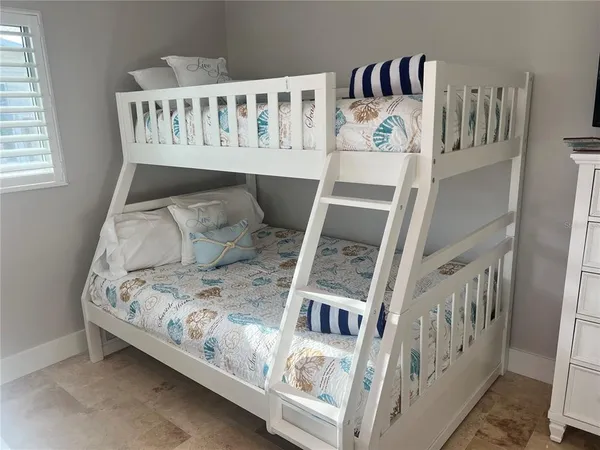 a view of a bedroom with furniture