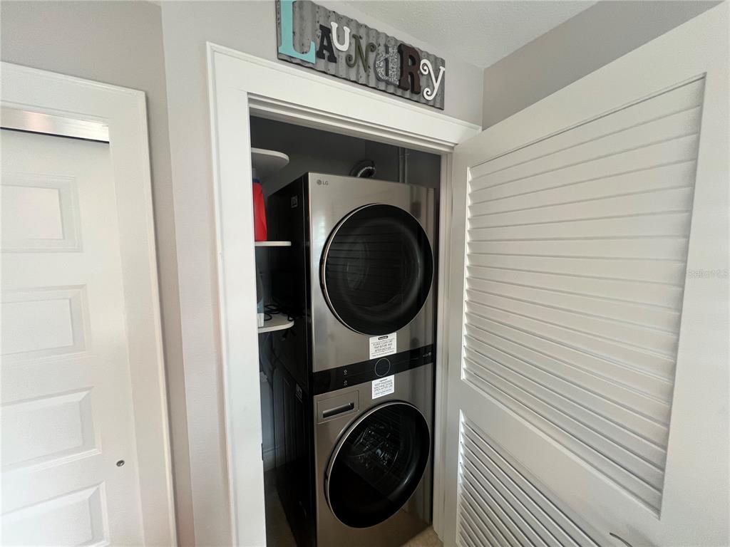 6020 Midnight Pass Road, Unit 22 Sarasota, FL 34242 - Photo 19 of 21 a close view of a utility room with dryer and washer