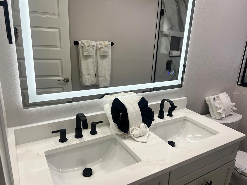6020 Midnight Pass Road, Unit 22 Sarasota, FL 34242 - Photo 20 of 21 a bathroom with a sink and a mirror