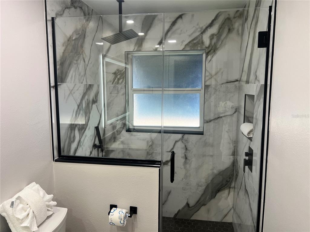 6020 Midnight Pass Road, Unit 22 Sarasota, FL 34242 - Photo 21 of 21 a bathroom with a bathtub and shower