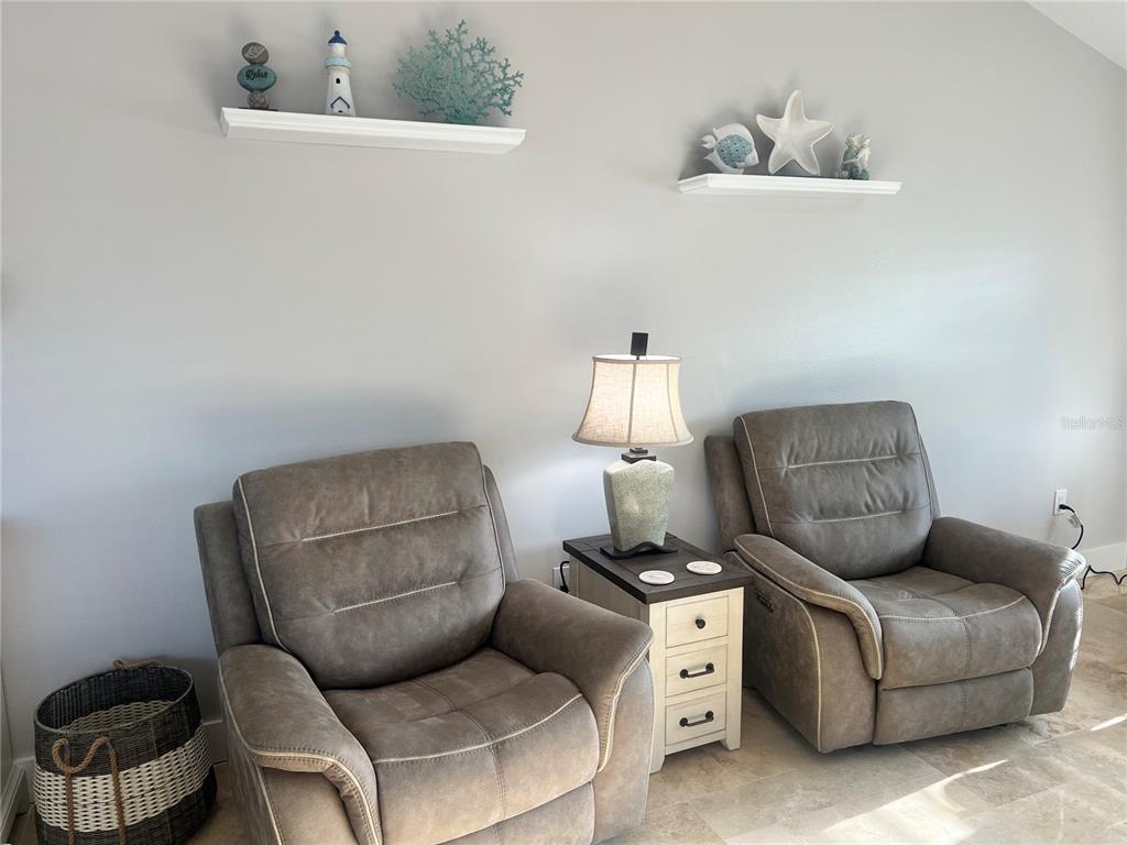 6020 Midnight Pass Road, Unit 22 Sarasota, FL 34242 - Photo 4 of 21 a living room with furniture a couch and a lamp