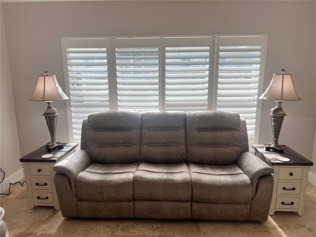 6020 Midnight Pass Road, Unit 22 Sarasota, FL 34242 - Photo 5 of 21 a living room with furniture a window and a lamp