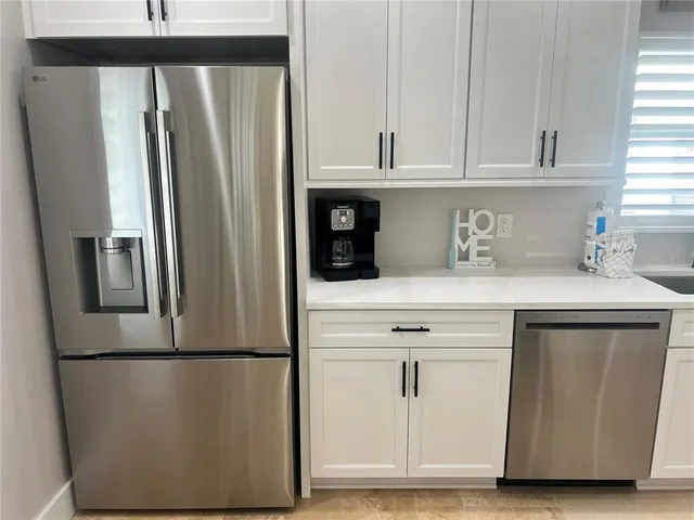 a kitchen with a refrigerator and cabinets
