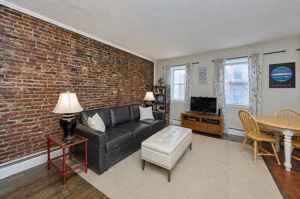 250 North Street, Unit 3 Boston, MA 02113 - Photo 1 of 11 a living room with furniture and a flat screen tv