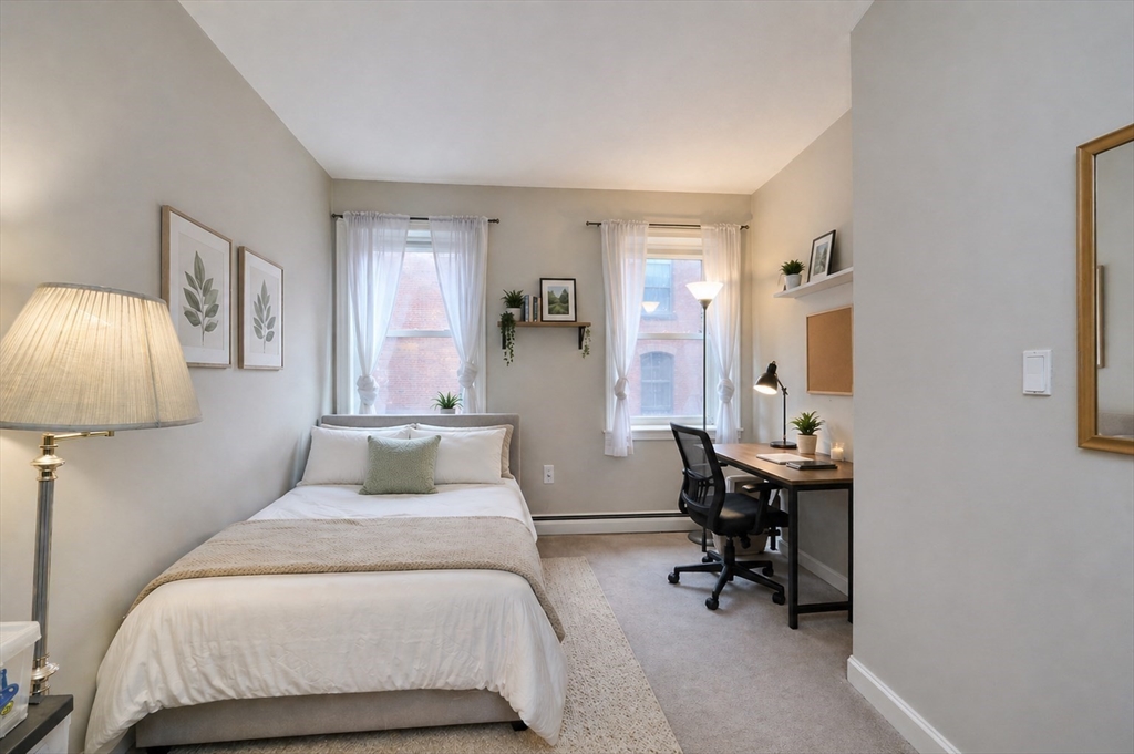 250 North Street, Unit 3 Boston, MA 02113 - Photo 11 of 11 a bedroom with a bed and a table in it