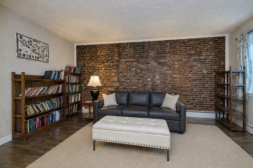 250 North Street, Unit 3 Boston, MA 02113 - Photo 3 of 11 a living room with furniture a rug and a book shelf