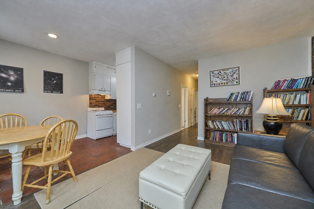 250 North Street, Unit 3 Boston, MA 02113 - Photo 4 of 11 a living room with furniture and a dining table with rug