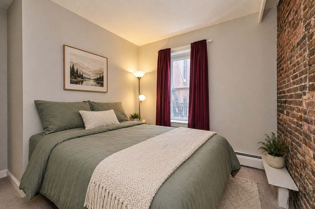 250 North Street, Unit 3 Boston, MA 02113 - Photo 9 of 11 a bedroom with a bed and a painting on the wall