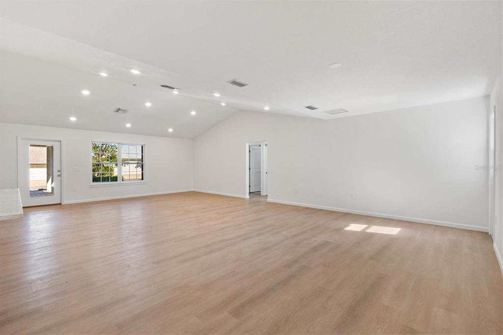 11041 Southeast 174th Loop Summerfield, FL 34491 - Photo 14 of 43 an empty room with wooden floor and windows