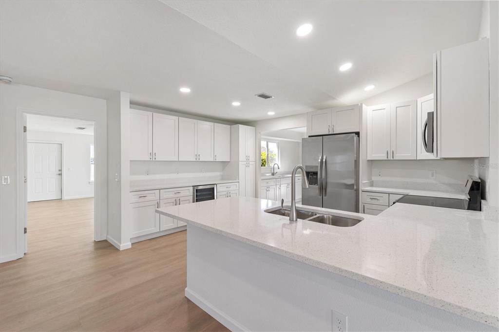 11041 Southeast 174th Loop Summerfield, FL 34491 - Photo 15 of 43 a kitchen with stainless steel appliances granite countertop a refrigerator and a sink
