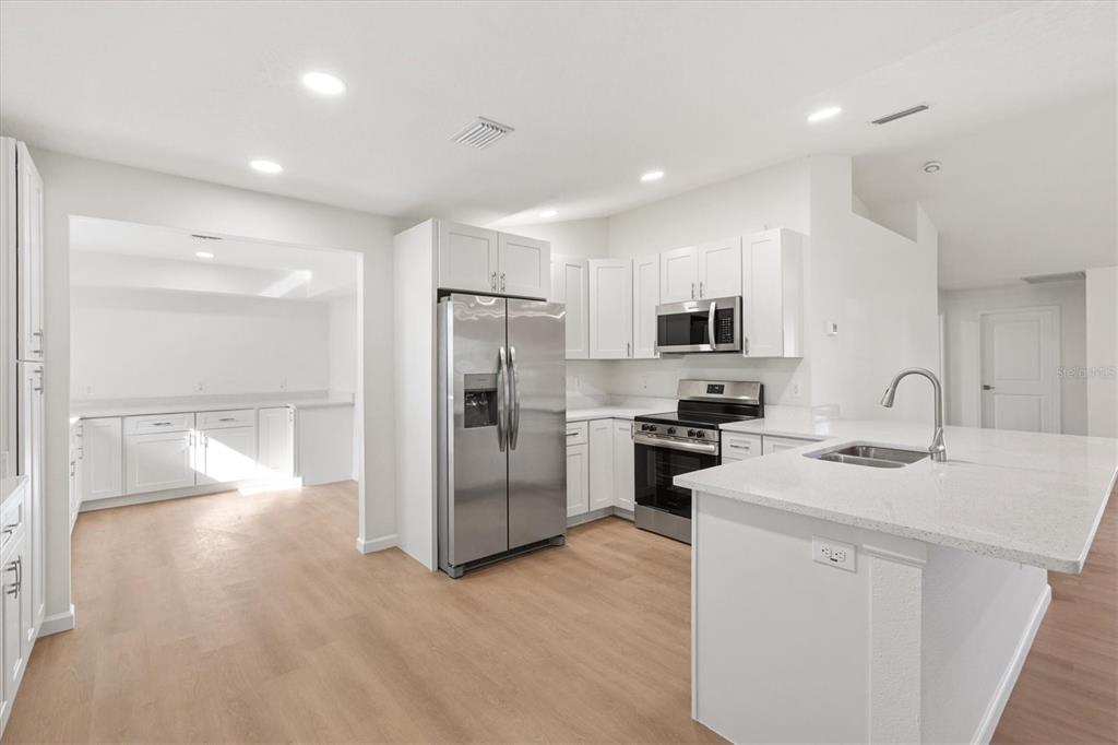 11041 Southeast 174th Loop Summerfield, FL 34491 - Photo 18 of 43 a kitchen with a sink stainless steel appliances and counter space