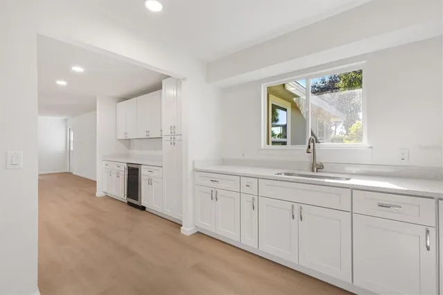 a spacious bathroom with a double vanity sink a window and a mirror