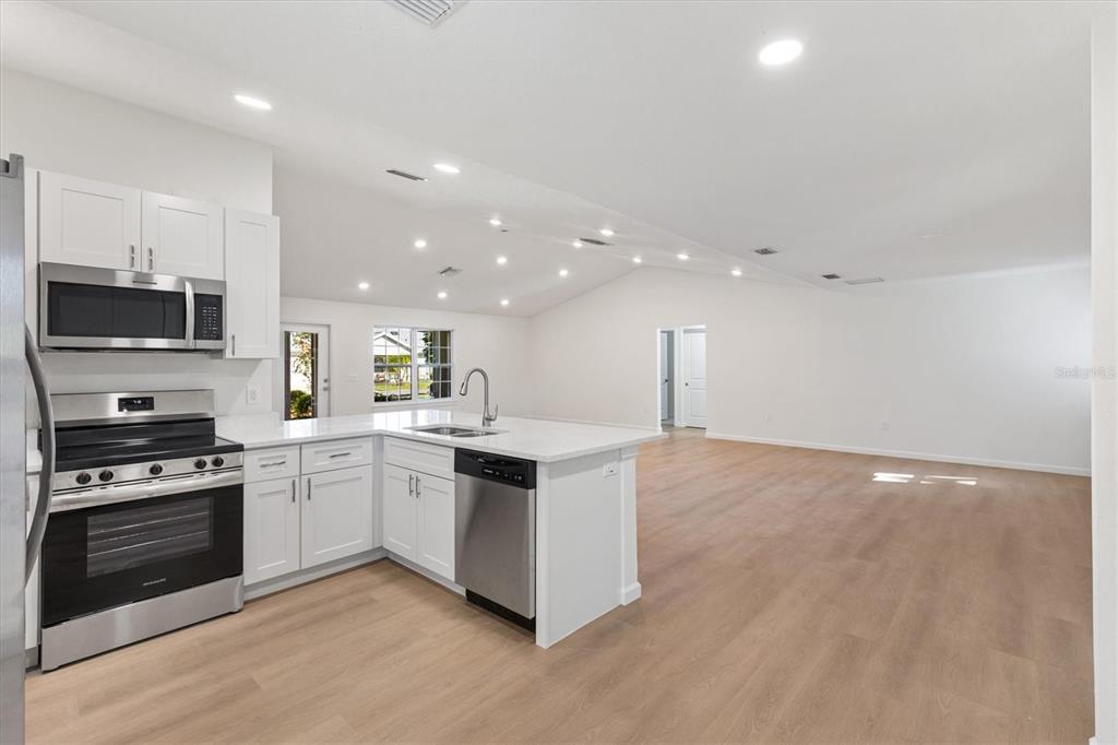 11041 Southeast 174th Loop Summerfield, FL 34491 - Photo 19 of 43 a kitchen with a stove and a microwave