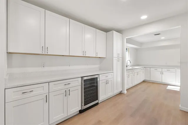 a kitchen with white cabinets