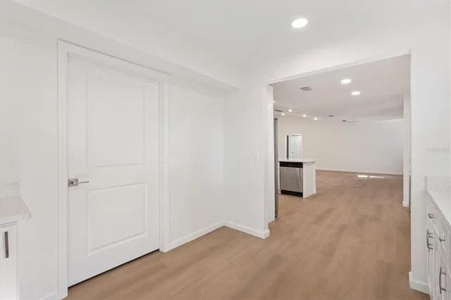 wooden floor in an empty room with a bathroom