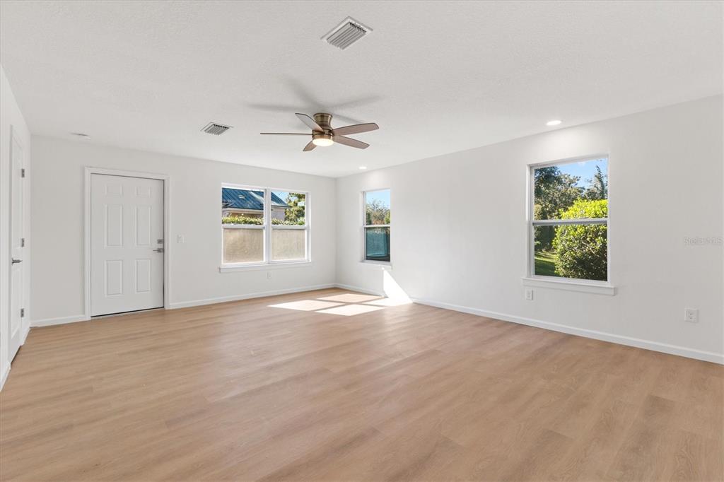11041 Southeast 174th Loop Summerfield, FL 34491 - Photo 26 of 43 an empty room with windows and ceiling fan