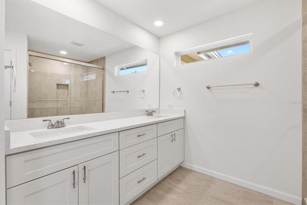 11041 Southeast 174th Loop Summerfield, FL 34491 - Photo 28 of 43 a spacious bathroom with a double vanity sink and mirror