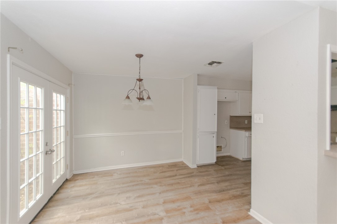 5330 Crossridge Drive Corpus Christi, TX 78413 - Photo 4 of 10 a view of empty room with wooden floor and windows