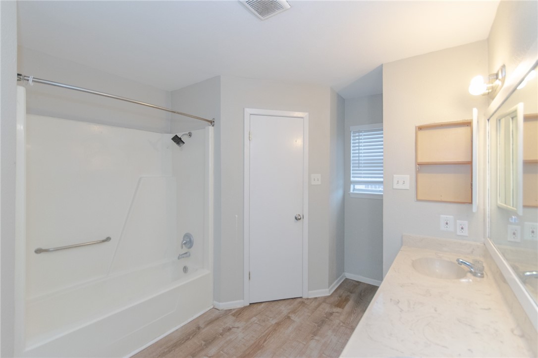 5330 Crossridge Drive Corpus Christi, TX 78413 - Photo 6 of 10 a bathroom with a tub shower and sink