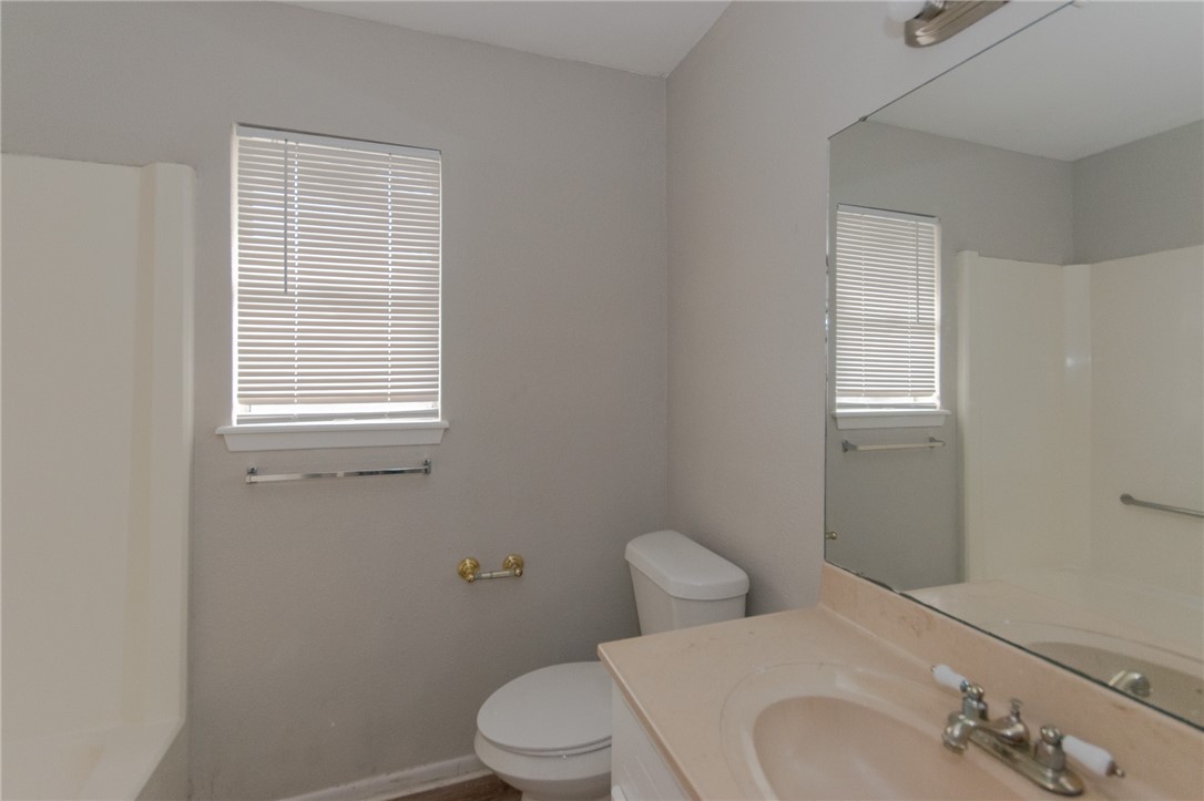 5330 Crossridge Drive Corpus Christi, TX 78413 - Photo 9 of 10 a white toilet sitting next to a bathroom sink