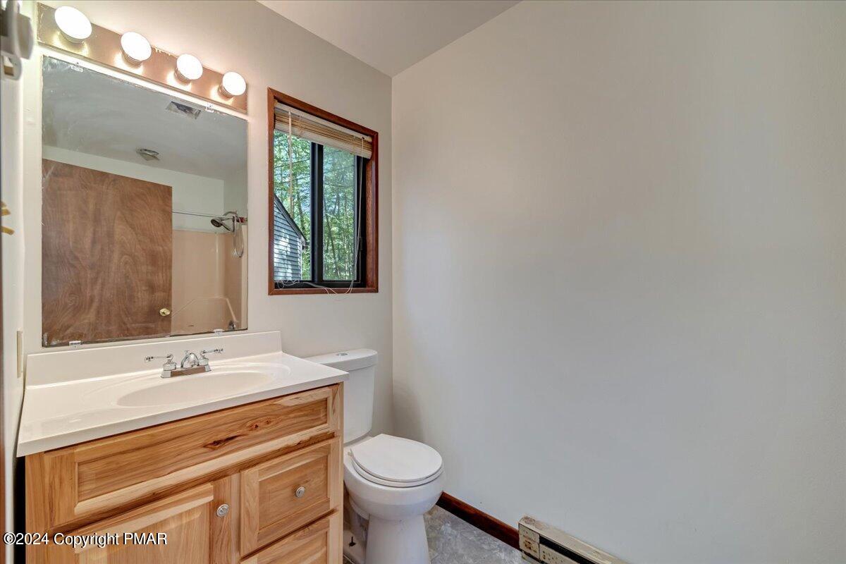 1182 Coolbaugh Road East Stroudsburg, PA 18302 - Photo 23 of 53 a bathroom with a sink toilet and mirror