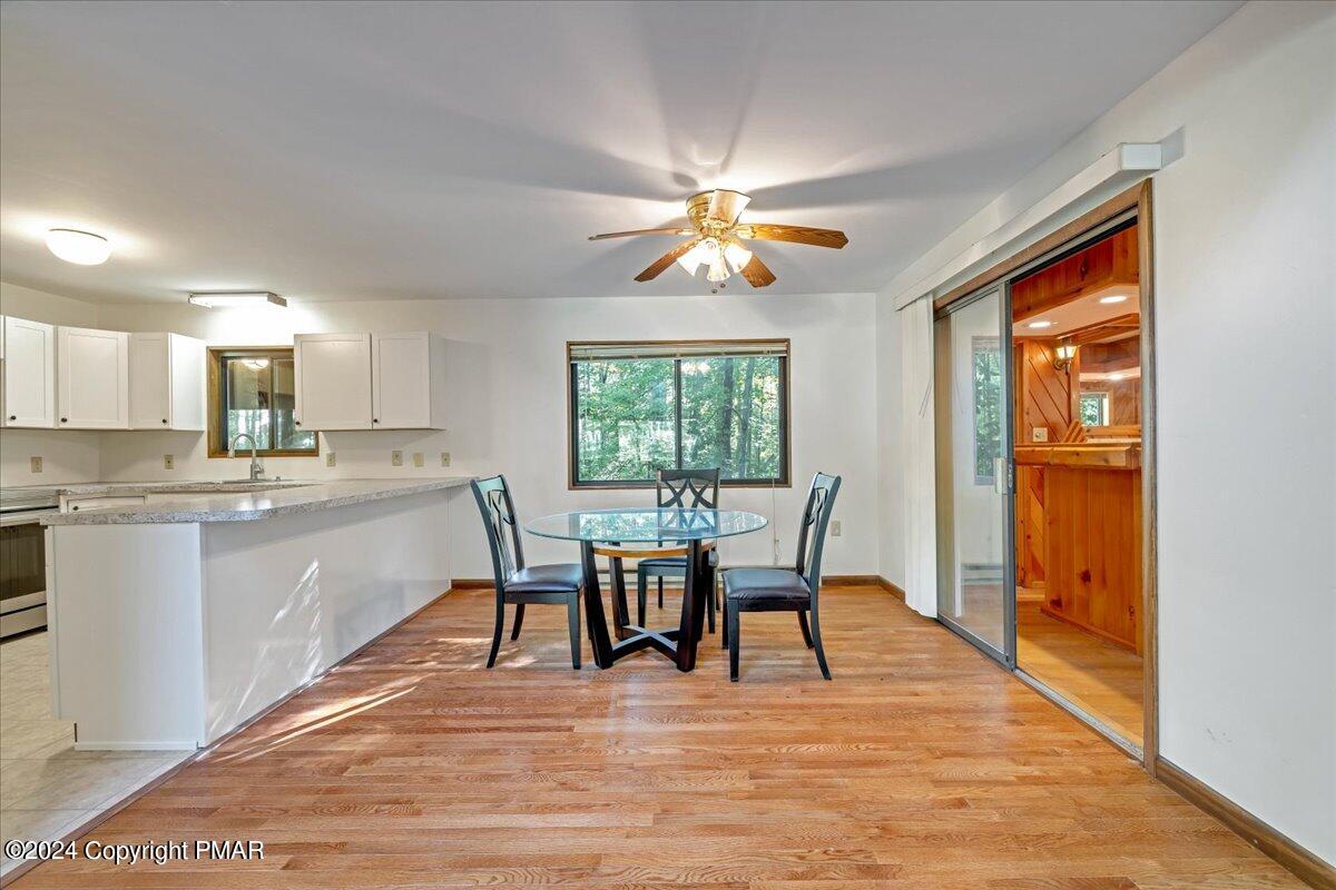 1182 Coolbaugh Road East Stroudsburg, PA 18302 - Photo 28 of 53 a view of a dining room with furniture a chandelier and wooden floor