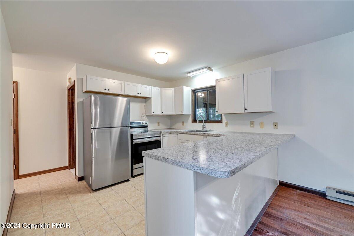 1182 Coolbaugh Road East Stroudsburg, PA 18302 - Photo 30 of 53 a kitchen with stainless steel appliances granite countertop a refrigerator a sink and a stove