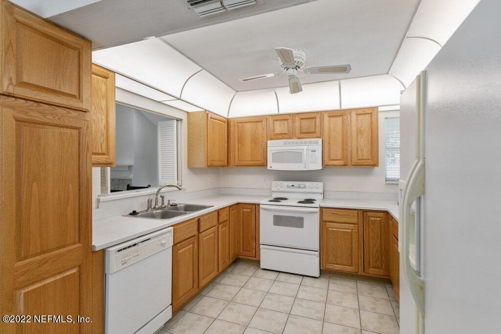 409 Village Drive St. Augustine, FL 32084 - Photo 13 of 75 a kitchen with a sink stove and cabinets