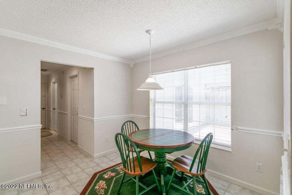 409 Village Drive St. Augustine, FL 32084 - Photo 16 of 75 a view of a dining room with furniture and window