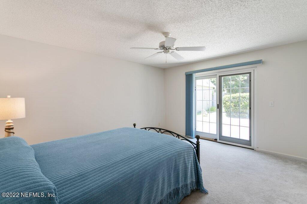 409 Village Drive St. Augustine, FL 32084 - Photo 17 of 75 a bedroom with a bed and a window