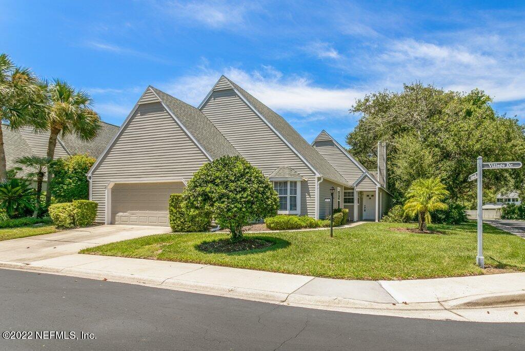 409 Village Drive St. Augustine, FL 32084 - Photo 2 of 75 a front view of a house with a yard and potted plants