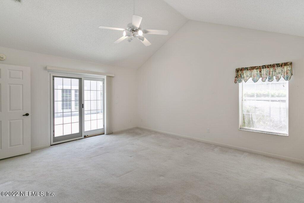 409 Village Drive St. Augustine, FL 32084 - Photo 26 of 75 an empty room with windows and fan