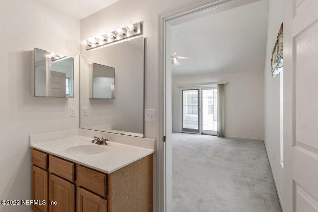 409 Village Drive St. Augustine, FL 32084 - Photo 27 of 75 a bathroom with a sink and a mirror