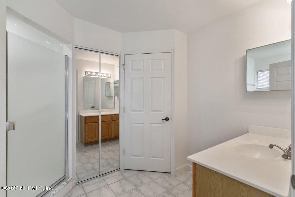 409 Village Drive St. Augustine, FL 32084 - Photo 28 of 75 a bathroom with a sink and a shower