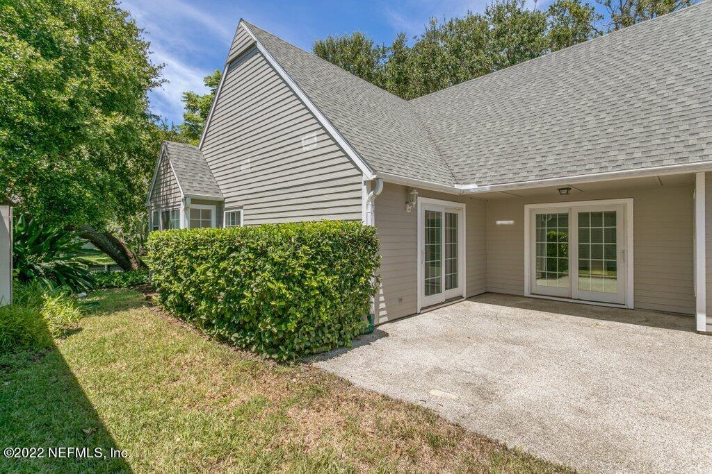 409 Village Drive St. Augustine, FL 32084 - Photo 33 of 75 a view of a house with a yard and potted plants