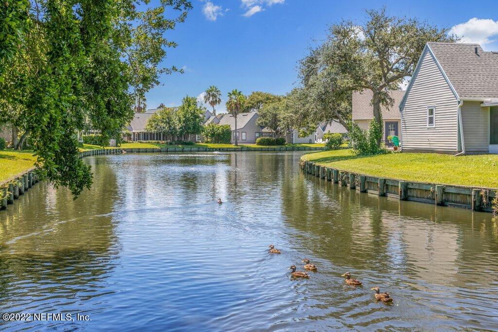 409 Village Drive St. Augustine, FL 32084 - Photo 38 of 75 a view of a lake with houses in the back