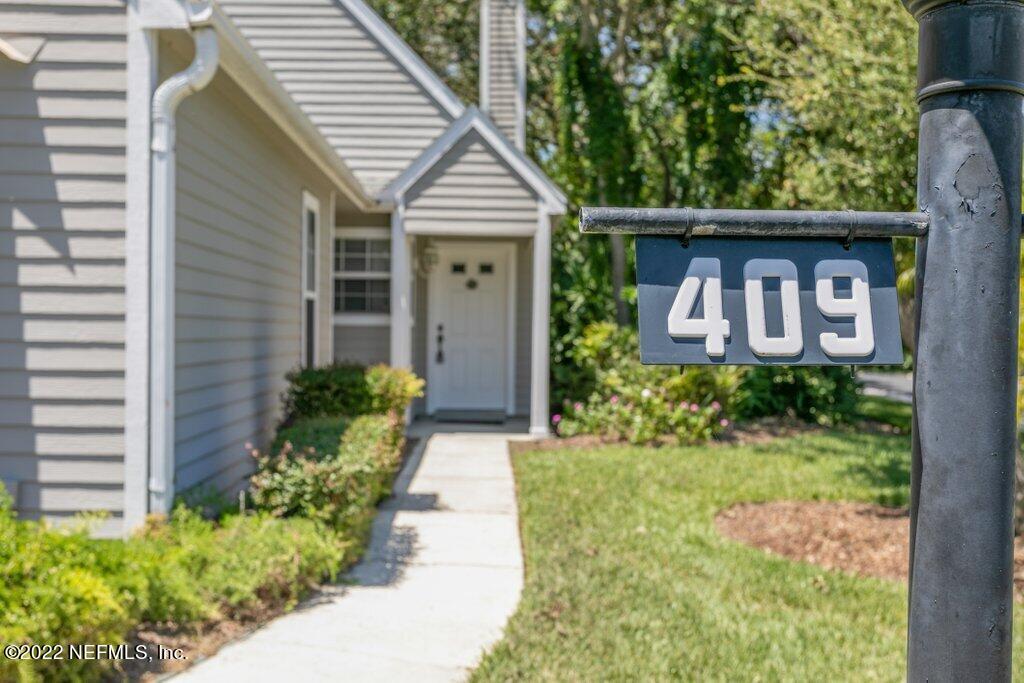 409 Village Drive St. Augustine, FL 32084 - Photo 4 of 75 a front view of a house with garden