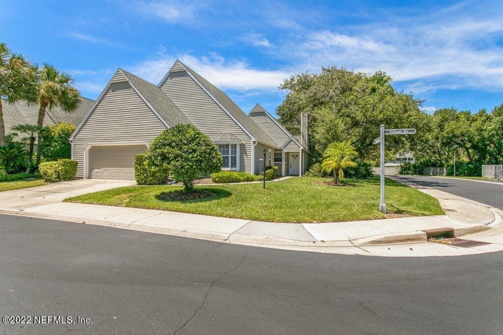 409 Village Drive St. Augustine, FL 32084 - Photo 41 of 75 a view of a house with a big yard plants and large trees