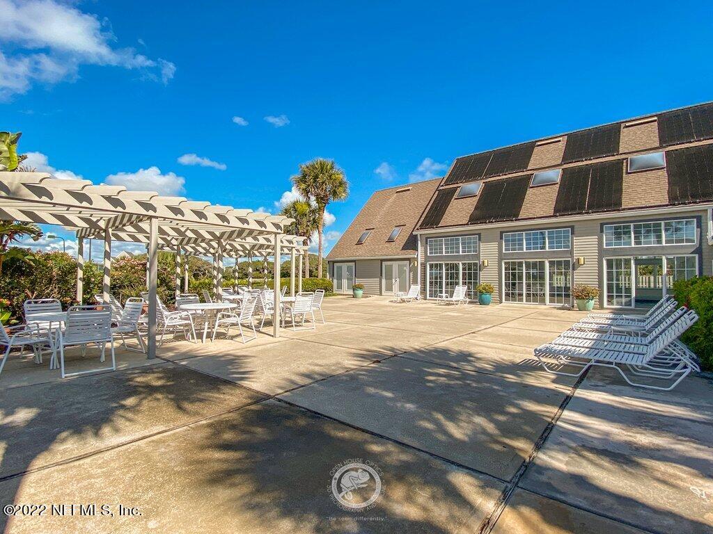 409 Village Drive St. Augustine, FL 32084 - Photo 60 of 75 a front view of a building with a garden