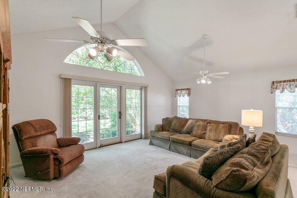 409 Village Drive St. Augustine, FL 32084 - Photo 7 of 75 a living room with furniture and a large window