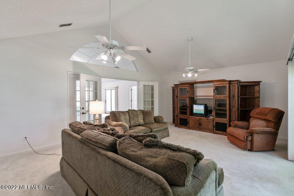 409 Village Drive St. Augustine, FL 32084 - Photo 8 of 75 a living room with furniture ceiling fan and a window