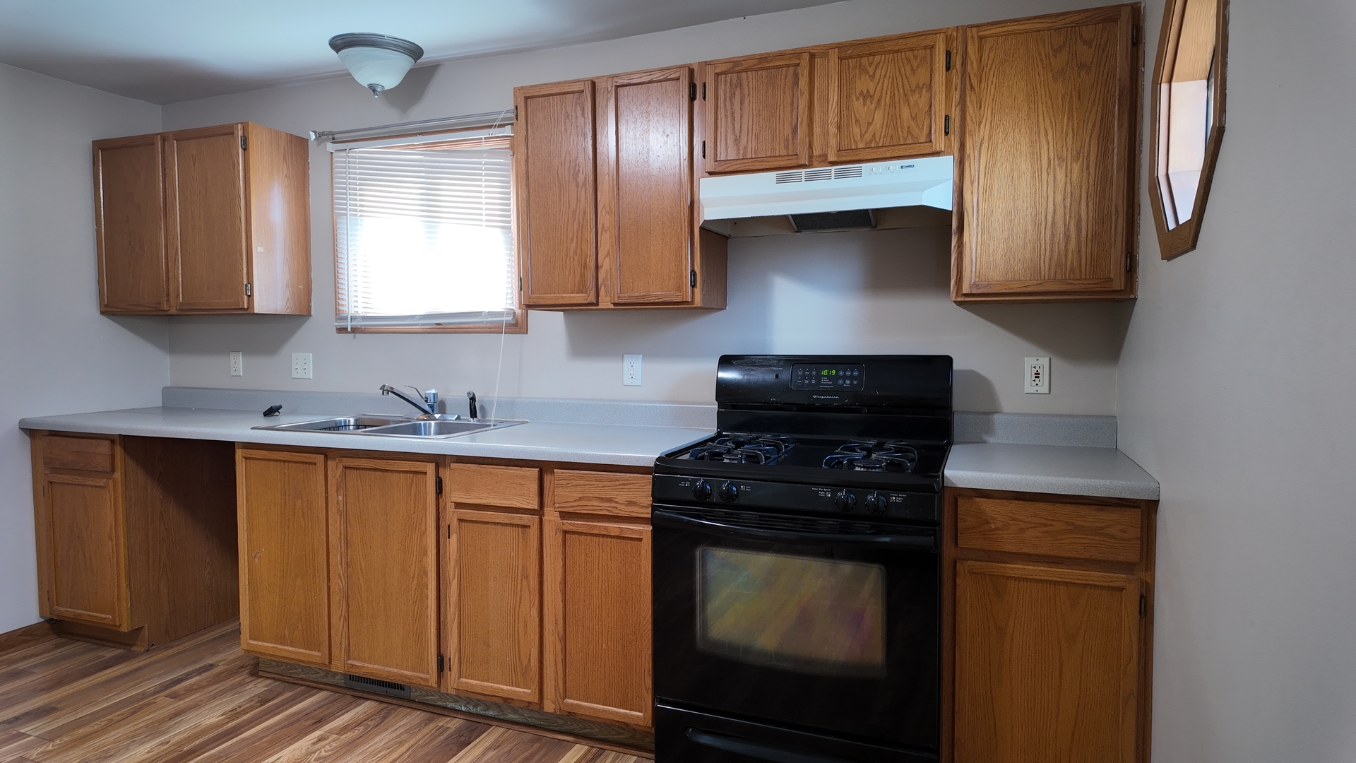 126 Prairie Street Genoa, IL 60135 - Photo 9 of 24 a kitchen with stainless steel appliances granite countertop a stove a sink and a microwave