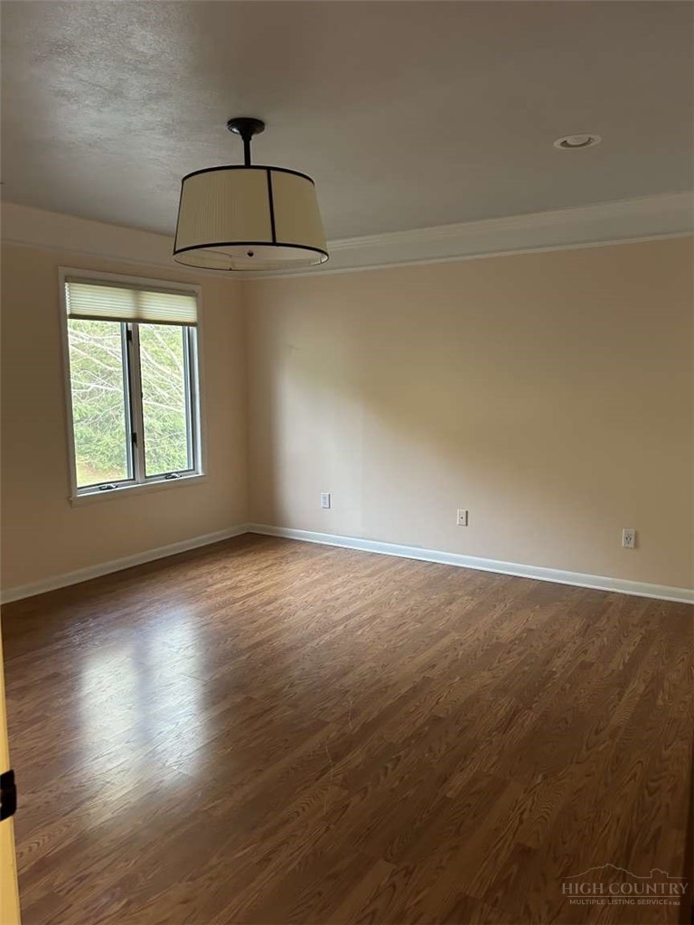 215 Meadow Ridge Road, Unit 19 Boone, NC 28607 - Photo 4 of 6 an empty room with wooden floor and windows