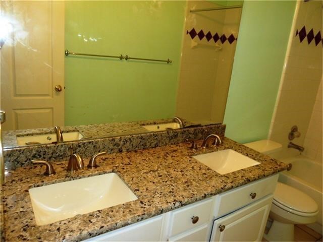 4542 Springfield Lakes Street Sugar Land, TX 77479 - Photo 16 of 16 Primary bathroom with dual sinks, expansive vanity, and large mirror.